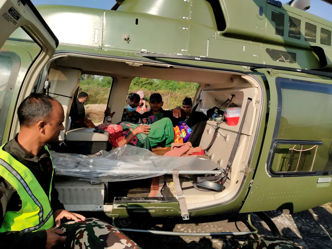 An injured person is seen inside a helicopter after an earthquake in Jajarkot